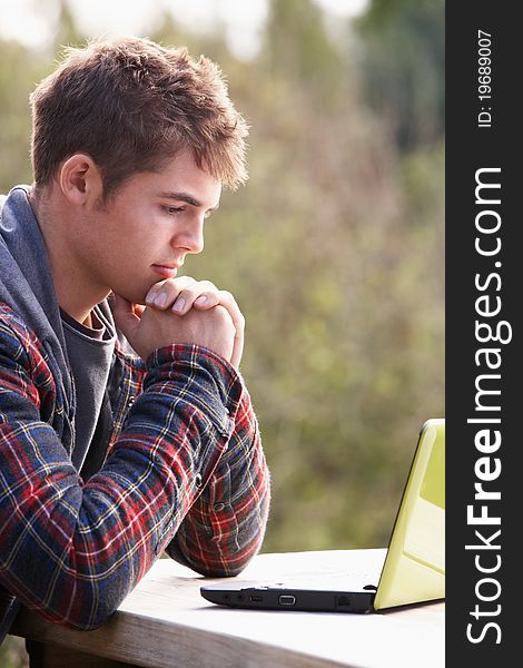 Young man with laptop computer concentrating
