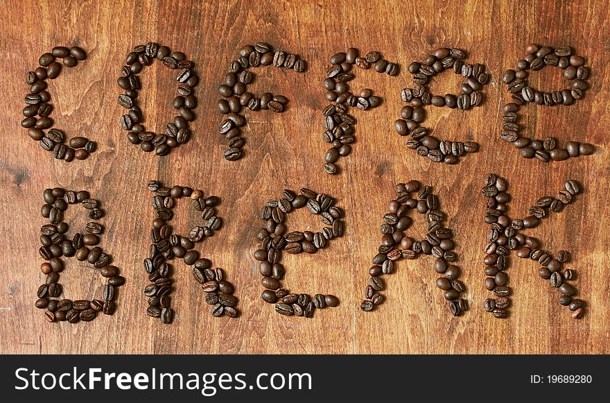 Coffee beans on wooden table, coffee break