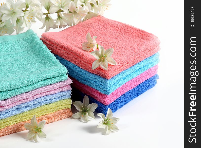 Colorful bath towels on white background.