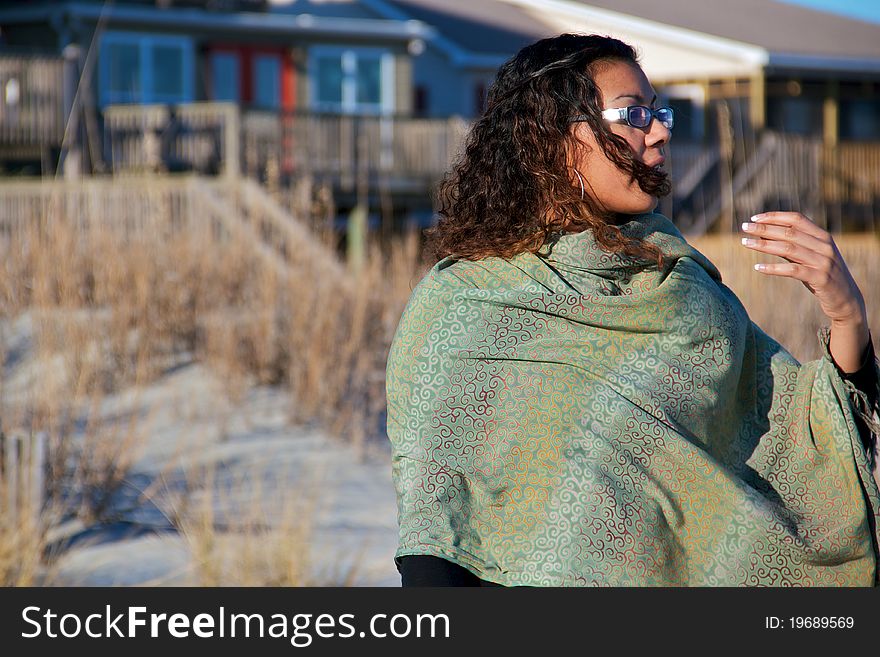 A women staring off into the ocean on a windy winter day. A women staring off into the ocean on a windy winter day