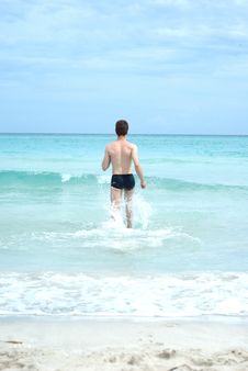 Happy Man Running Into The Ocean Royalty Free Stock Photo