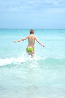 Young Woman Running Into The Ocean Royalty Free Stock Photography Young Woman Running Into The Ocean Royalty Free Stock Photography