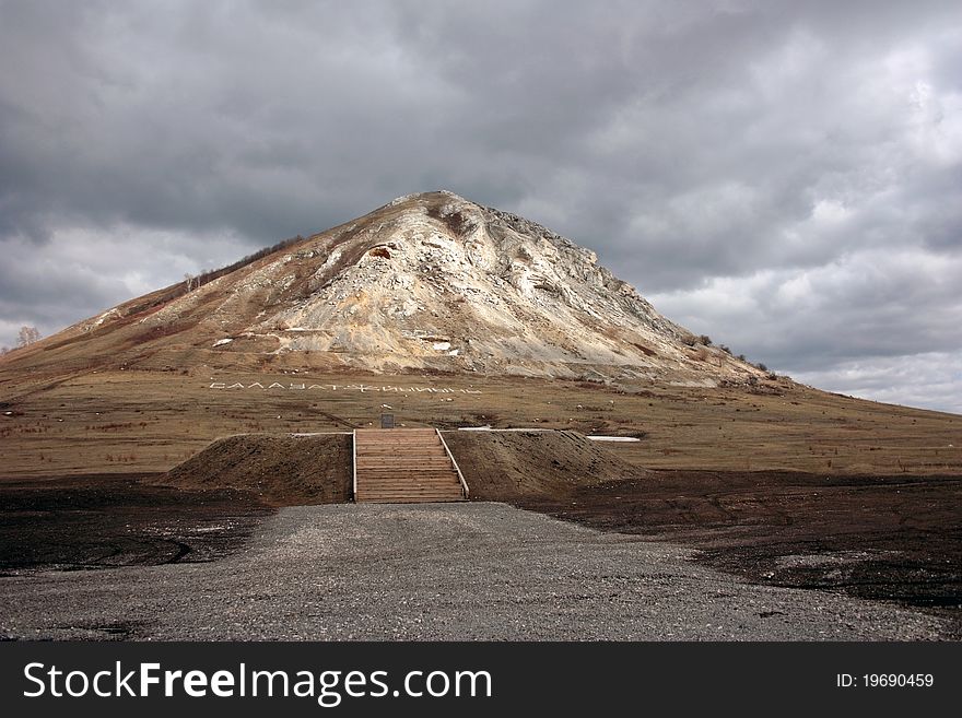 High Mountain On A Background Of The Cloudy Sky