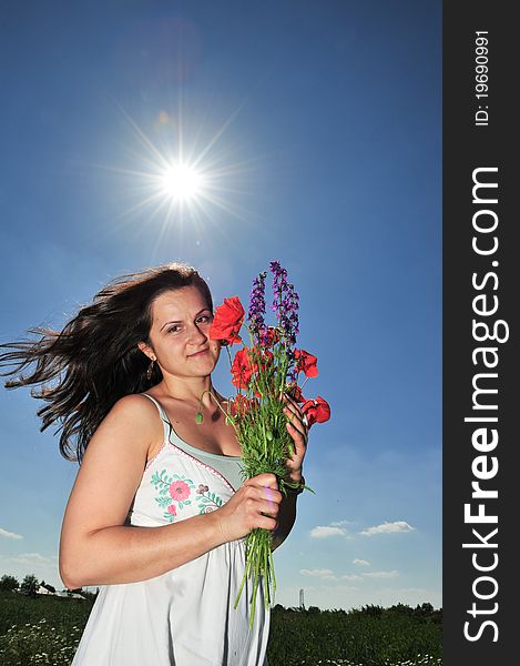 Young pregnant woman under bright clear blue sky. Young pregnant woman under bright clear blue sky