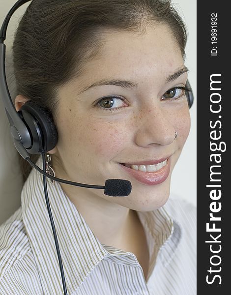 Young secretary with headset taking a call