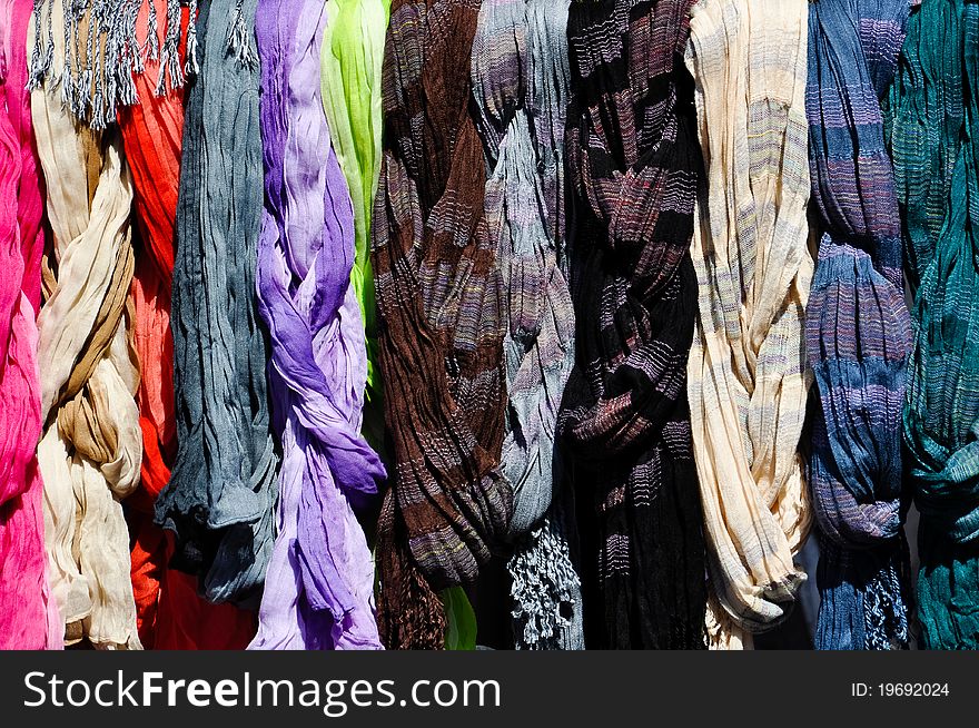 A set of colorful scarves on a rack on a local market in vienna