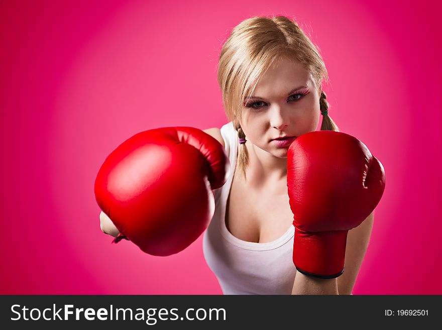 Beautiful young girl with boxing gloves. Beautiful young girl with boxing gloves