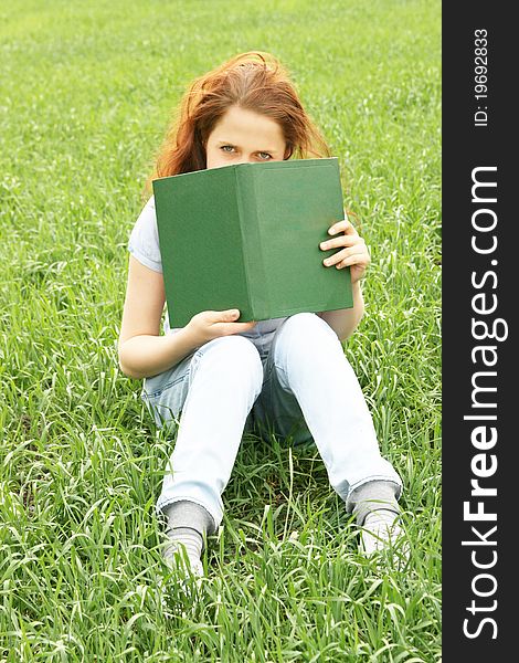 Girl on the grass with a book