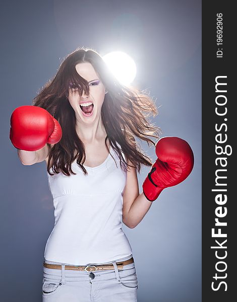 Beautiful young girl with boxing gloves. Beautiful young girl with boxing gloves