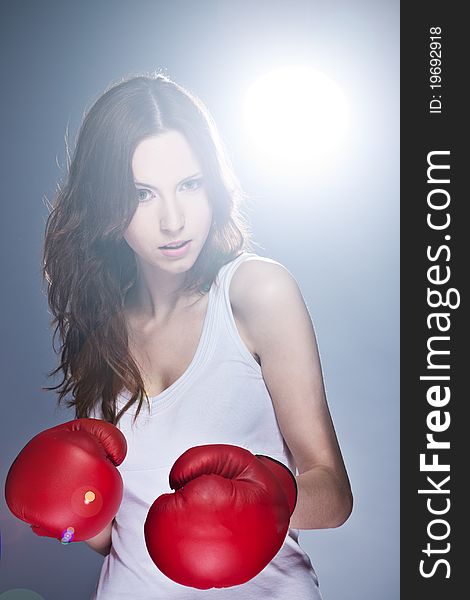 Beautiful young girl with boxing gloves. Beautiful young girl with boxing gloves