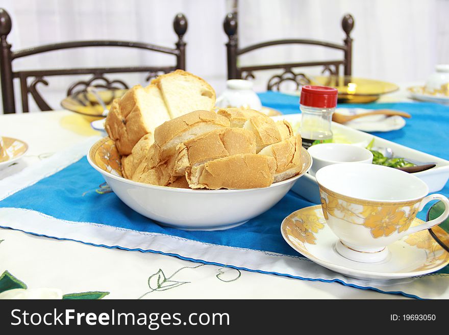 A table is prepared for breakfast with English bread served as the main food.