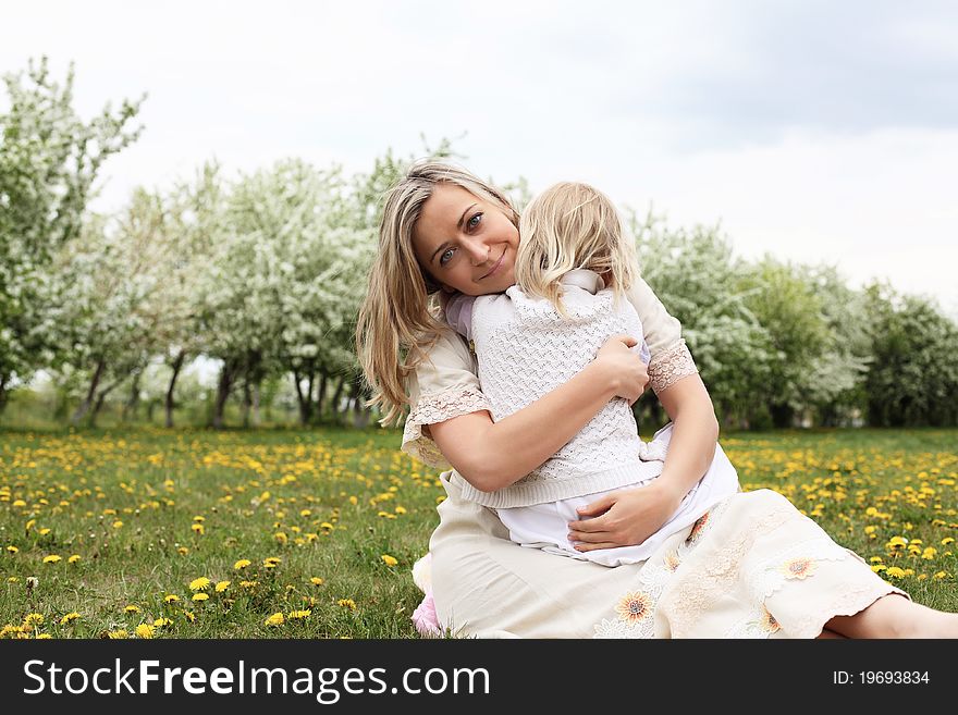 Happy girl and her mother in the spring park. Happy girl and her mother in the spring park