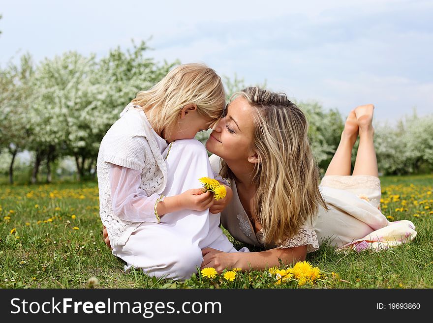 Happy girl and her mother in the spring park. Happy girl and her mother in the spring park