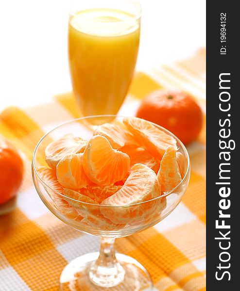 Fresh tangerines and juice in glass