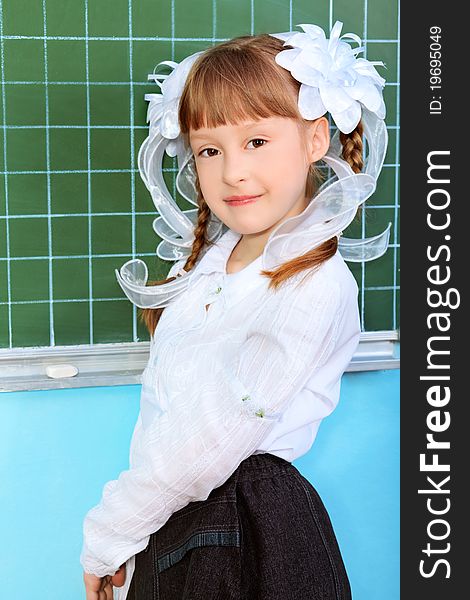 Portrait of a pretty schoolgirl in a classroom.