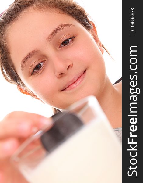 Girl eating cookies and milk over white background