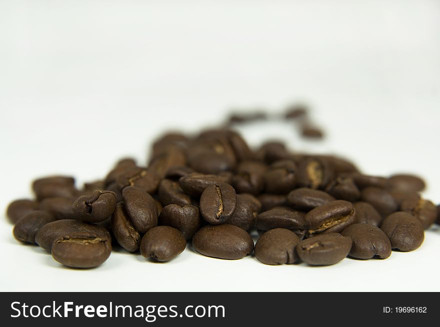 Toasted coffee beans, isolated background.
