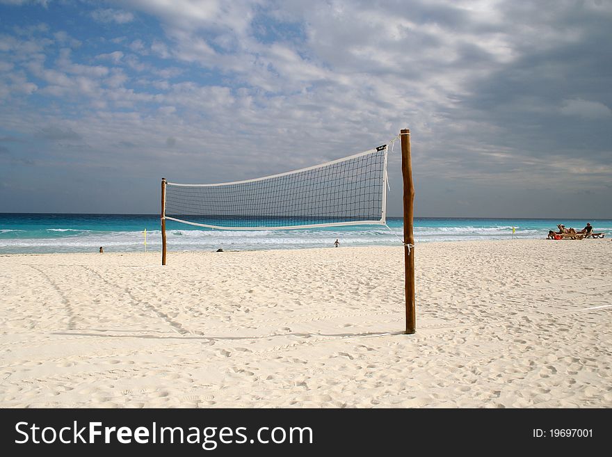 Volleyball net set up on sandy beach at the ocean
