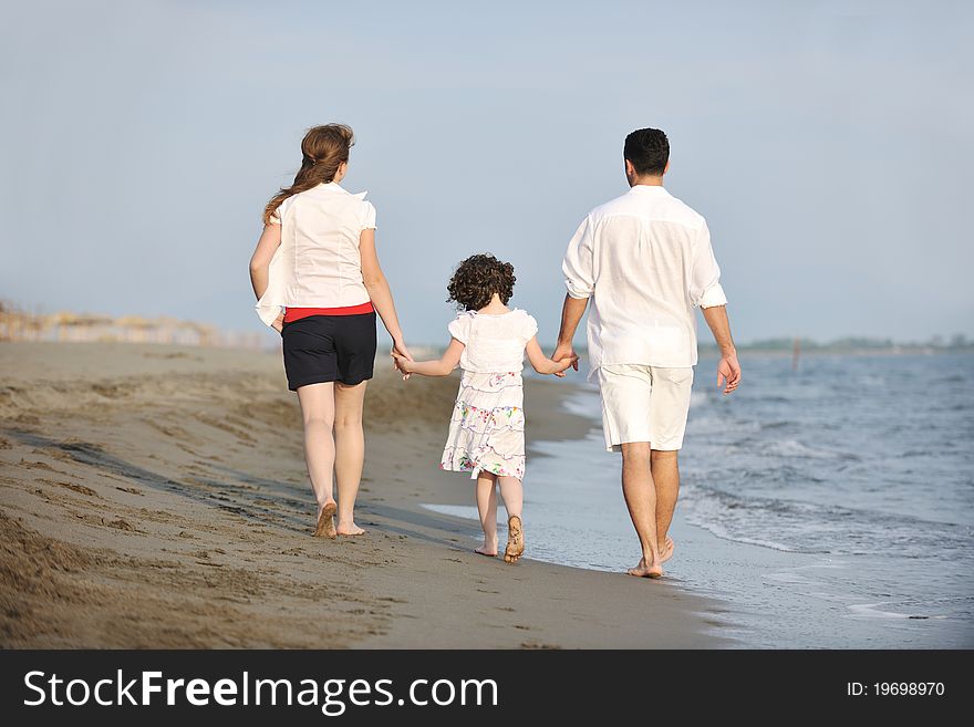 Happy young family have fun and live healthy lifestyle on beach. Happy young family have fun and live healthy lifestyle on beach
