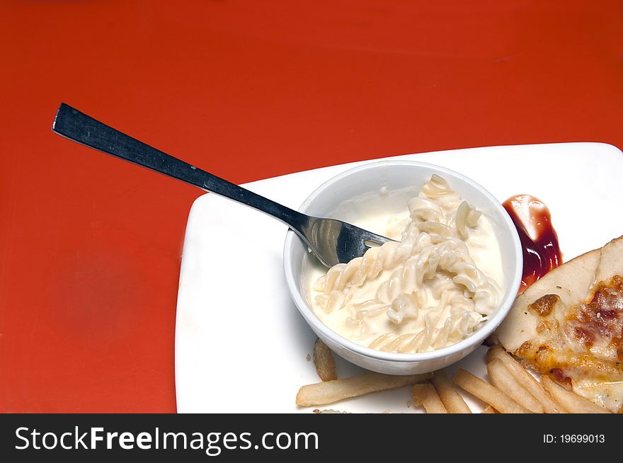 Pasta and french fries at a restuarant table with coy space at the top