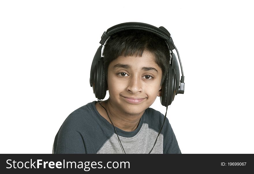 An handsome Indian kid enjoying music with lots of fun