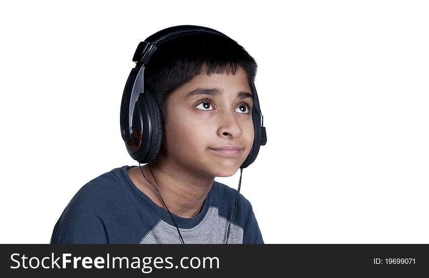 An handsome Indian kid enjoying music with lots of fun