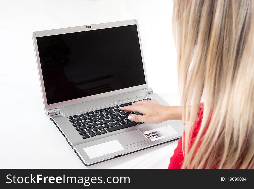 Happy working woman sitting on the floor with her laptop