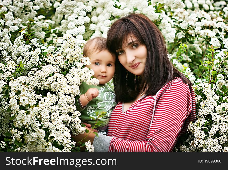 Woman and child among the flowering trees. Woman and child among the flowering trees