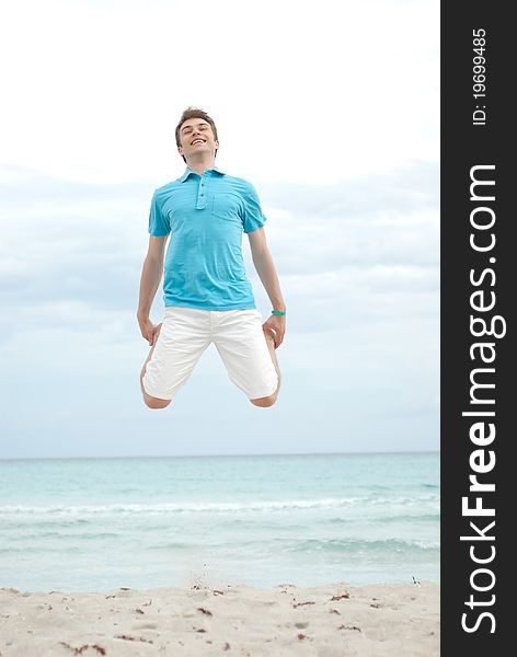 Young Man Jumping On The Beach