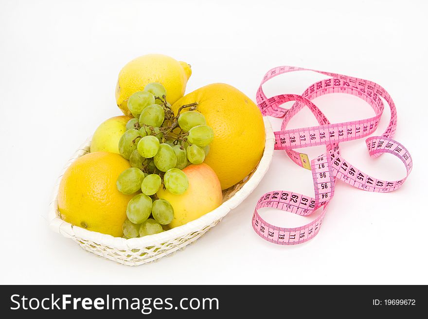 Fresh fruits and measuring tape