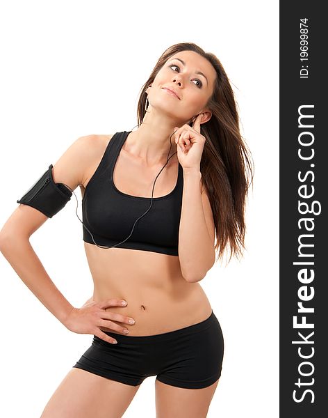 Happy young fitness beautiful slim brunette sport woman listening music isolated on a white background. Happy young fitness beautiful slim brunette sport woman listening music isolated on a white background