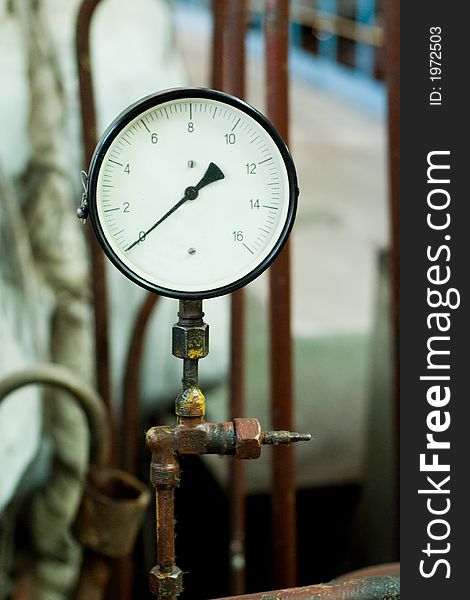 Antique pressure control device on the rusty pipe