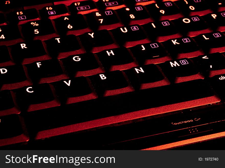 laptop keyboard with red colour tint