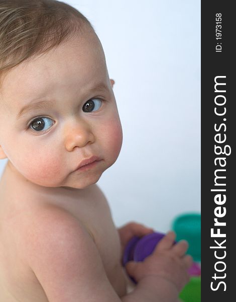 Image of adorable baby playing with stacking cups. Image of adorable baby playing with stacking cups