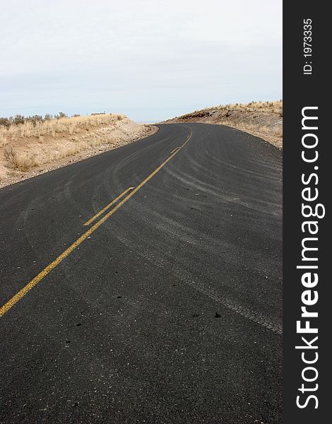 Curve in paved highway with dusty car tracks; clean, crisp, sharp image. Curve in paved highway with dusty car tracks; clean, crisp, sharp image.