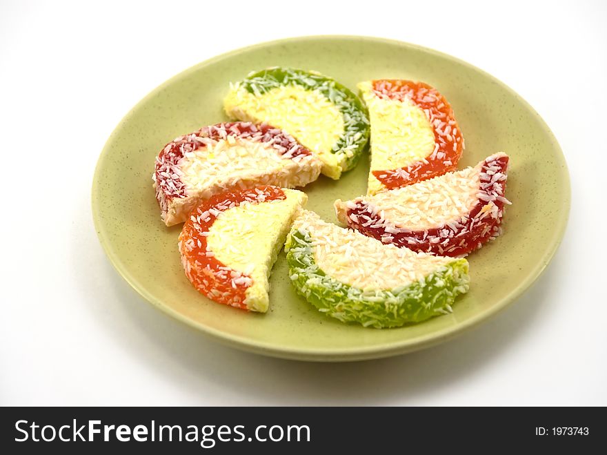 Beautiful fruit candy on a plate on a white background