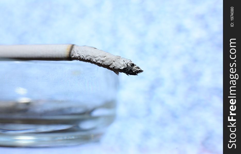 Cigarette close-up on a blue background