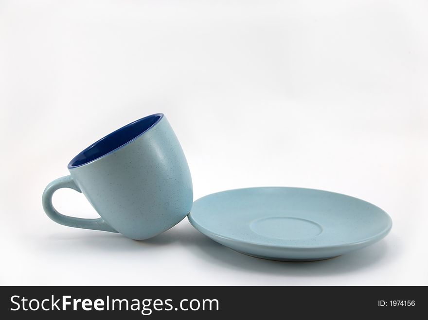 Blue mug with a plate on a white background
