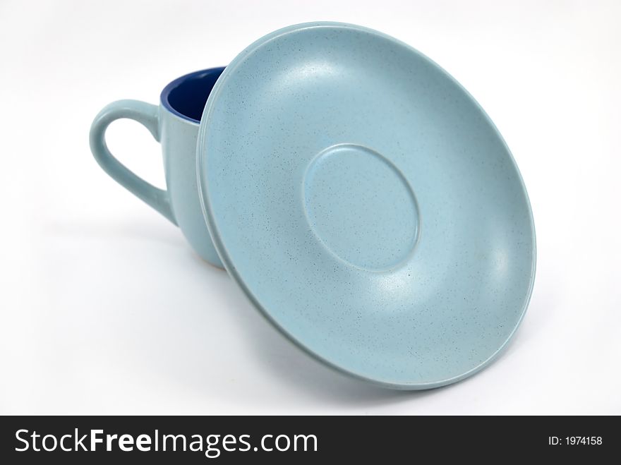 Blue mug with a plate on a white background