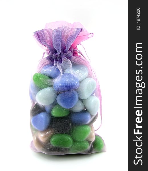 Beautiful package with decorative stones on a white background