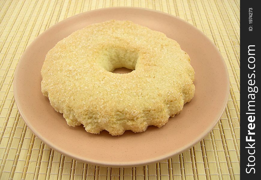 Beautiful sugar fruitcake and a plate on a bamboo napkin