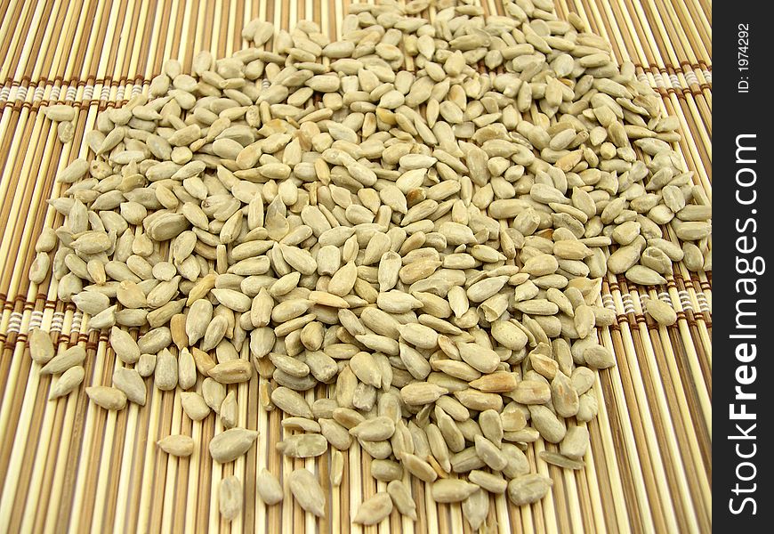 The beautiful cleared sunflower seeds on a bamboo napkin