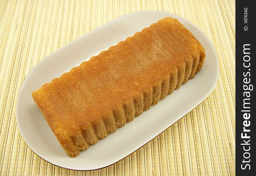 Beautiful fruitcake in a plate on a bamboo napkin