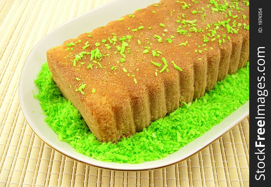 Beautiful fruitcake in a plate on a bamboo napkin