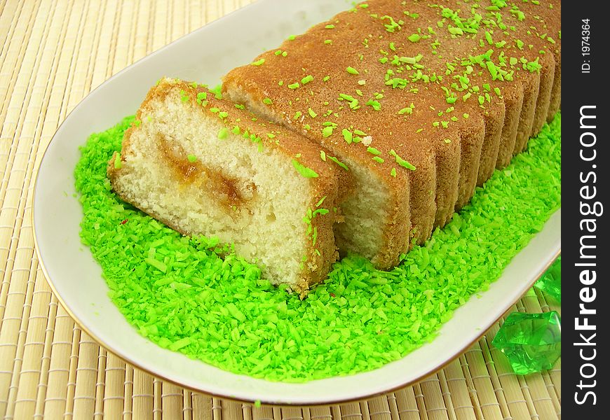 Beautiful fruitcake in a plate on a bamboo napkin