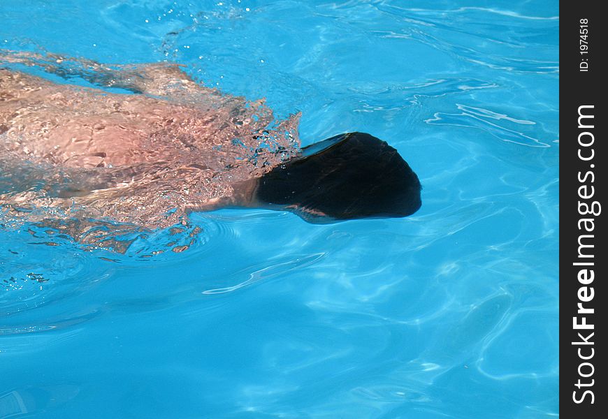 Man swimming in outdoors, blue water