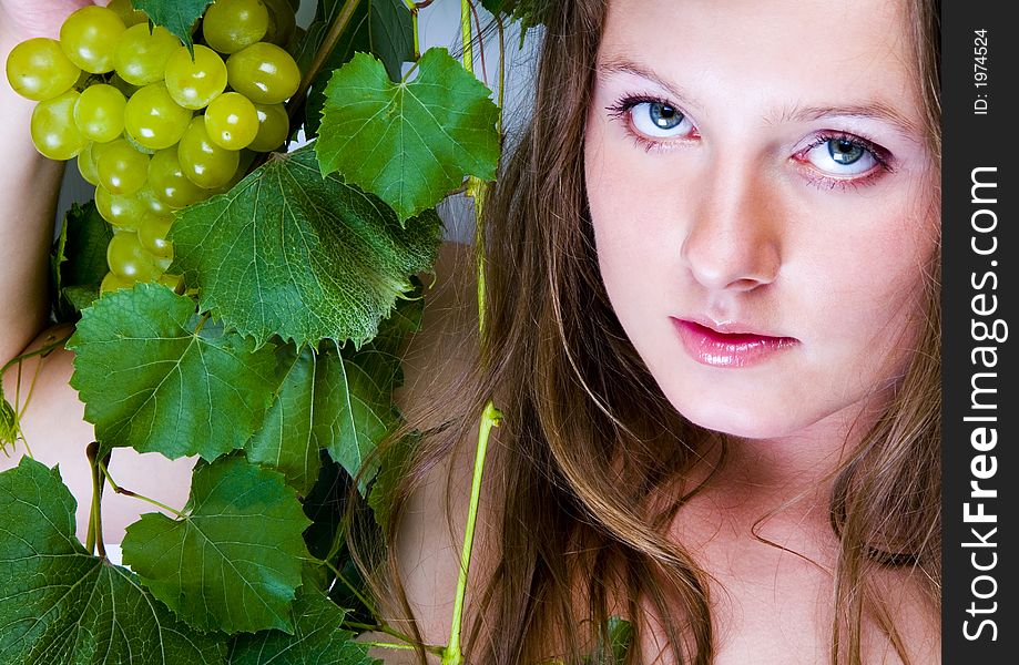 Beautiful young woman portrait with green grape. Beautiful young woman portrait with green grape