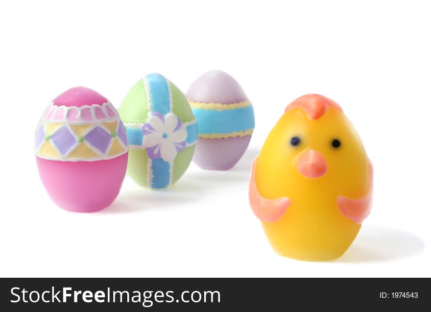 Pastel colored, wax Easter eggs on white background. Lots of DOF with focus on the chick egg leading his egg team. Unsharpened.