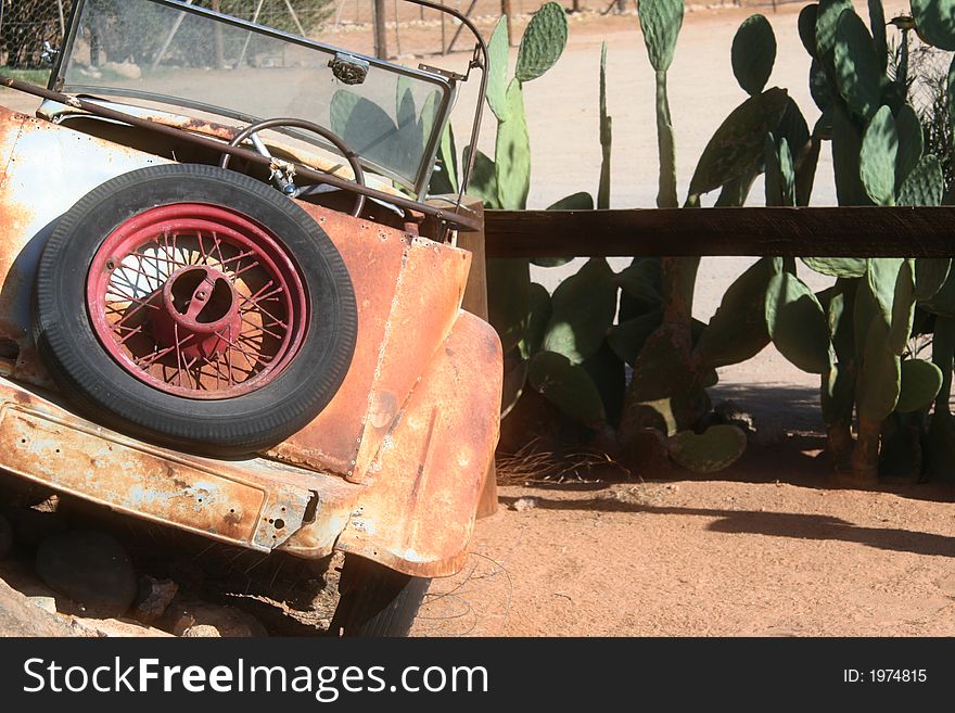 Old car abandoned in a desert town in a parking lot