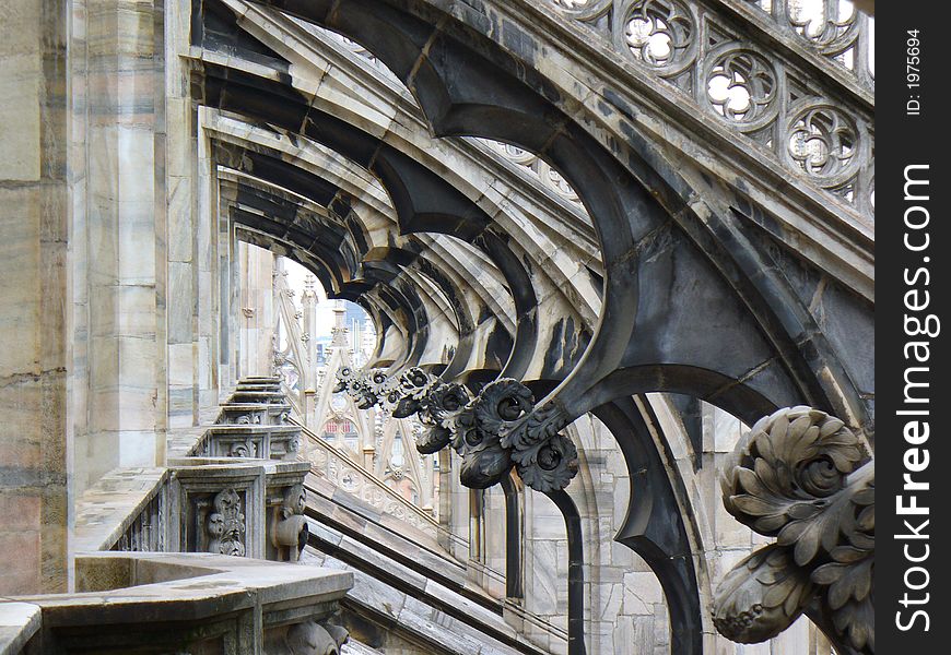 View through area in the decorative roof of Duomo cathedral in Milan. View through area in the decorative roof of Duomo cathedral in Milan